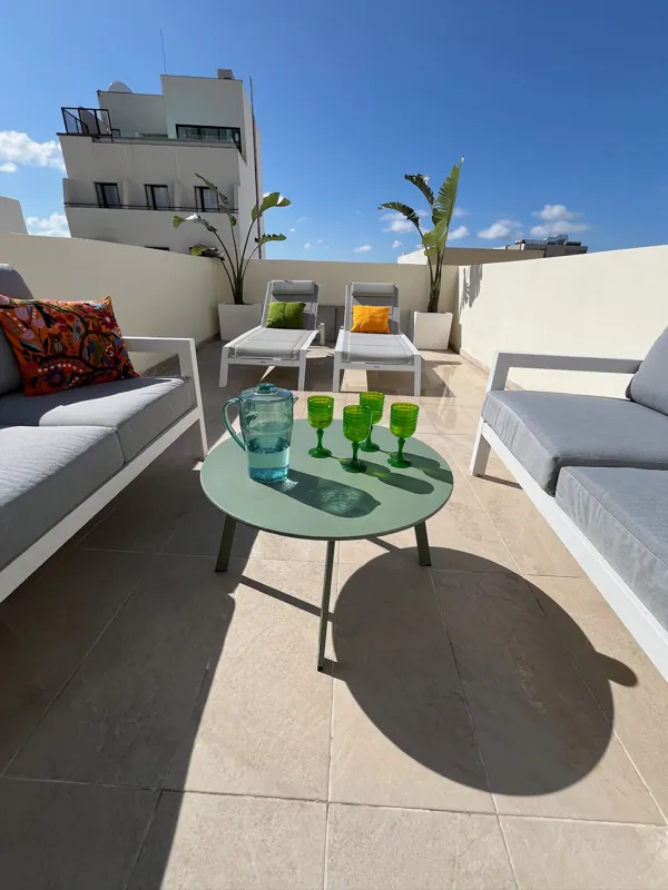 Back terrace with two sun loungers and outdoor sofas